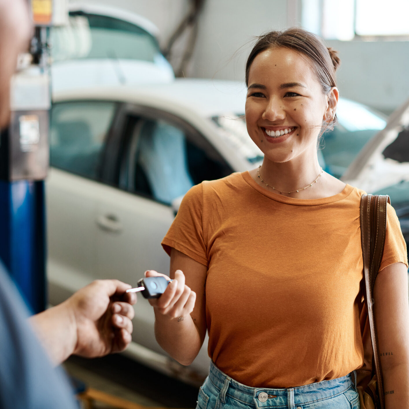 Shot of a woman receiving her car keys We take care of cars and the people who drive them